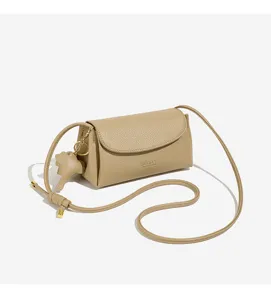 Retro minimalist women's cross-body shoulder bag detail view with elegant design and compact charm.