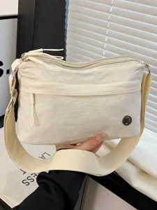 Versatile nylon crossbody bag for women, multi-layer lightweight shoulder bag casual daily use.