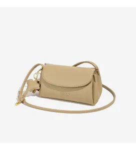 Detail view of the retro minimalist women's crossbody bag featuring a cute bear pendant.