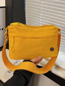 Yellow nylon small crossbody bag for women, multi-layer stylish casual shoulder handbag.