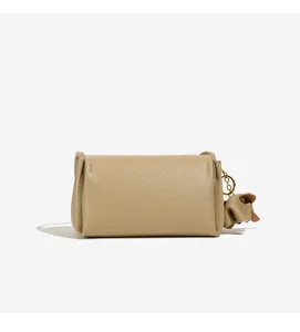 Detailed view of a stylish khaki leather mini handbag, showing fine texture and cute side charm.