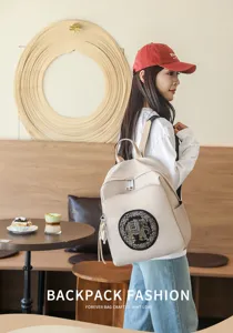 Casual beige backpack featuring exquisite elephant embroidery and sleek metal hardware details.