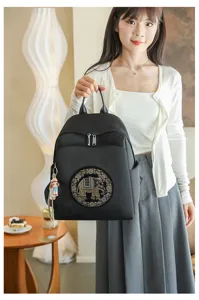 Stylish black casual travel backpack featuring rhinestone elephant pattern for women daily use.