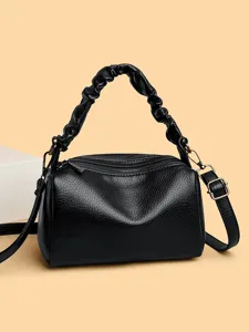 Black leather pillow bag for women, retro crossbody handbag with scrunchie handle and strap.