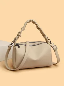 Elegant beige pillow shoulder bag for women, stylish crossbody handbag with ruched handle.