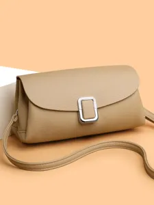 Retro minimalist women leather crossbody bag with elegant flap design and chic metal buckle.