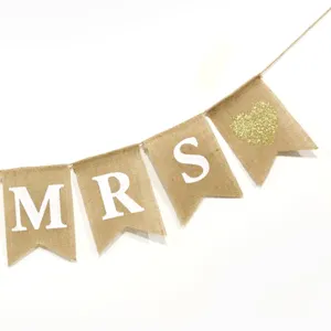 Dettaglio bandierina di juta con lettere MRS e cuore glitterato, decoro matrimonio.