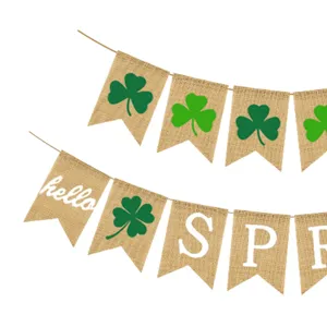 Close-up detail of spring burlap bunting banner featuring green clover and hello spring print.