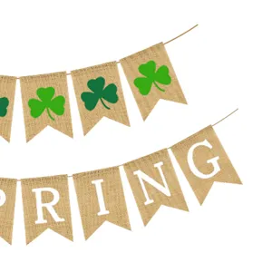 Close-up detail of spring burlap banner with green shamrocks and festive letter prints.