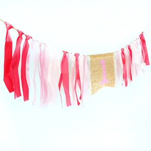 Details of pink and white ribbon burlap high chair banner for baby first birthday party.