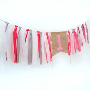 Details of 1st birthday high chair ribbon banner with burlap flag for baby party decoration.