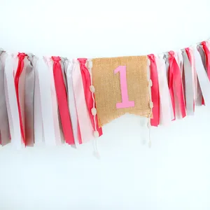 Adorable first birthday high chair banner featuring pink number one and colorful fabric ribbons.