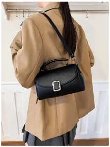 Stylish black leather shoulder bag with top handle and metal buckle for elegant daily outfits.