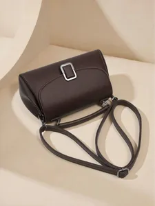 Elegant dark brown leather shoulder bag with chic metal buckle, premium daily accessory.