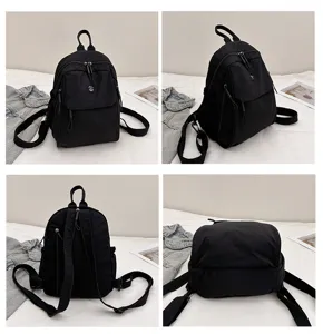 Detailed view of the multi-angle black nylon backpack showing zippers, straps, and pockets.