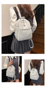 Detailed view of casual multi-layer nylon backpack, large capacity light grey daily bag for women