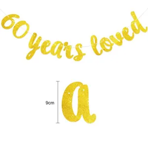 Gold glitter 60 years loved banner garland featuring 9cm letter height for anniversary party.
