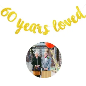 Detail view of the 60 years loved gold glitter banner for 60th birthday party decor.