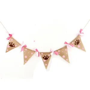 Jute pet party banner featuring cute paw prints and pink polka dots for celebration.