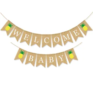 Detail view of burlap welcome baby banner with cute pineapple prints for party decor.