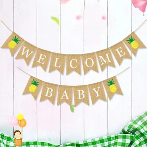 Detail view of rustic burlap welcome baby banner with cute pineapple prints for party.