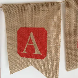Burlap banner detail showing rustic jute fabric texture with red letter A print for decor.