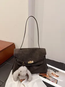 Vintage faux suede shoulder bag for women, retro tote handbag with metal lock and cute charm.