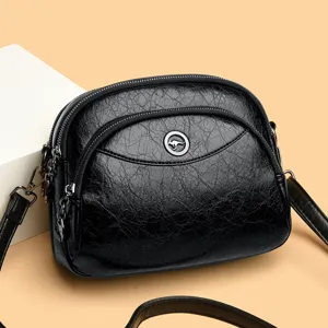 Stylish black leather cross-body bag with multiple zippers and metallic kangaroo logo design.