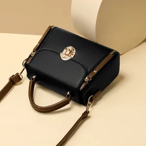 Stylish black top handle handbag with brown straps and gold lock closure, casual chic design.