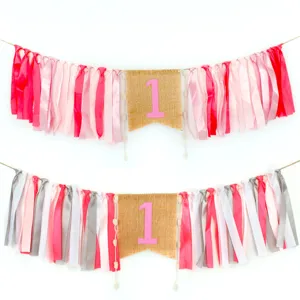 Birthday high chair banner set with colorful ribbons and burlap number one flag for party.