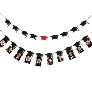 Detailed close-up view of the graduation party banner featuring photo clips and mortarboard cutouts.