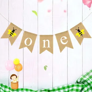 Detailed view of the cute bee first birthday burlap banner with rustic wooden backdrop.