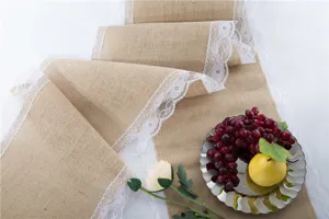 Burlap table runner with white lace trim, rustic hessian fabric for wedding and party decor.