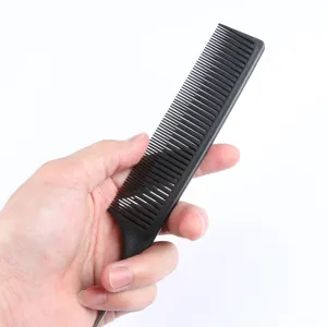Detail view of black hair styling tail comb, professional hairdressing tool for salon use.
