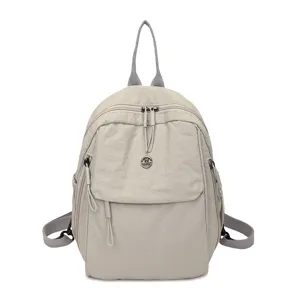 Minimalist nylon casual backpack for women, stylish light gray daily travel bookbag.