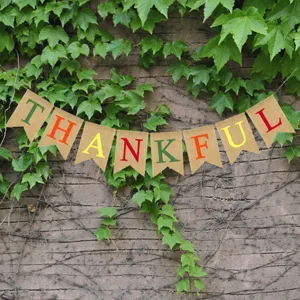 Detail view of rustic burlap Thanksgiving banner with colorful letter prints for party decor.