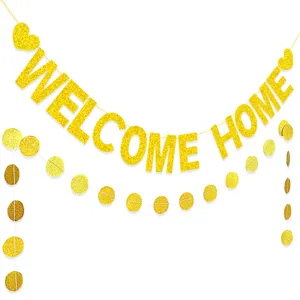 Gold glitter welcome home banner close-up, sparkling paper letter garland for party decor.