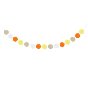 Detail view of colorful felt pom pom garland for Easter party decor, hanging vibrant balls.
