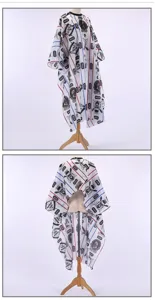 Professional salon haircut cape detail showing waterproof polyester fabric and printed barber shop pattern.