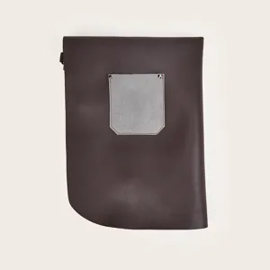 Detail view of a retro minimalist dark brown leather work apron with grey chest pocket.
