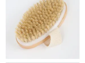 Detail view of oval wooden bath brush with natural bristles and comfortable cotton handle strap.