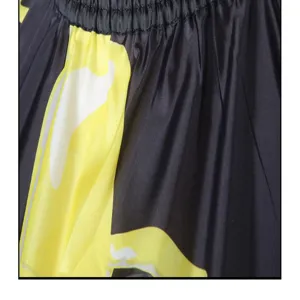 Detail view of the professional hair cutting cape showing elastic neckline and smooth fabric.