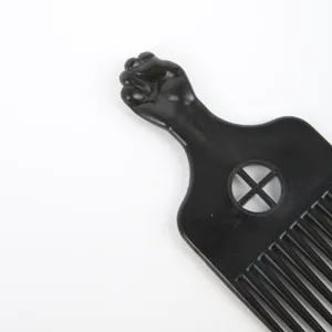 Black plastic afro pick comb with clenched fist handle for men hair styling and pompadour.