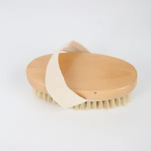 Wooden boar bristle bath brush with soft cotton strap for deep body exfoliation spa use.