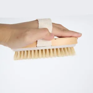 Natural bristle bath brush with wooden handle and cotton strap for gentle body exfoliation.