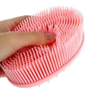 Pink silicone shampoo brush for scalp massage, soft bristles for dry and wet hair care use.