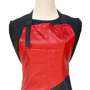 Professional salon haircut apron with waterproof red layer, adjustable strap, adult hairstyling.