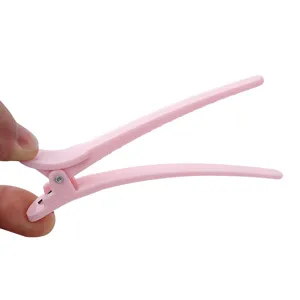 Pink plastic hair sectioning clip duckbill styling tool for salon styling and daily hair care.