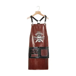 Vintage PU leather barber apron with cross back straps and tool pockets for salon styling.
