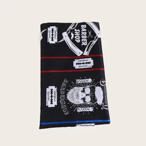 Professional black barber cape with vintage skull and razor print for salon haircut use.